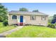Charming home featuring a quaint front yard with grass and decorative black mulch at 1432 Almand Creek Drive Sw, Conyers, GA 30094