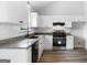 Bright kitchen boasts white cabinetry, granite countertops, and stainless steel appliances at 1432 Almand Creek Drive Sw, Conyers, GA 30094