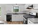 Modern kitchen features white cabinets, granite countertops, and stainless steel appliances at 1432 Almand Creek Drive Sw, Conyers, GA 30094