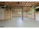 Unfinished basement with exposed wood beam ceiling and two windows providing natural light for future living or storage space at 1432 Almand Creek Sw Dr, Conyers, GA 30094