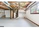 Spacious unfinished basement with exposed ductwork and potential for renovation with natural light coming through the window at 1432 Almand Creek Sw Dr, Conyers, GA 30094