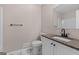 Neutral bathroom with a toilet, vanity with granite countertop, and a sleek black faucet, offering modern comfort at 1432 Almand Creek Sw Dr, Conyers, GA 30094