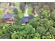 Aerial perspective of a residential neighborhood with mature trees and a manicured lawn at 7972 Woods Lane, Jonesboro, GA 30236