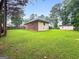 Spacious backyard featuring lush green grass and mature trees, perfect for outdoor activities at 7972 Woods Lane, Jonesboro, GA 30236