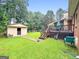 Lush backyard features mature trees and shed at 7972 Woods Lane, Jonesboro, GA 30236