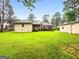 Large, open backyard with mature trees, offering plenty of space for recreation and relaxation at 7972 Woods Lane, Jonesboro, GA 30236