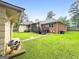 Expansive backyard featuring a brick home and outdoor deck area at 7972 Woods Lane, Jonesboro, GA 30236