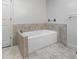 Bathroom featuring a built-in tub with marble surround at 7972 Woods Lane, Jonesboro, GA 30236