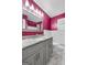 Bathroom featuring granite counters, gray cabinets, and a large mirror above the sink at 7972 Woods Lane, Jonesboro, GA 30236