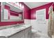 Bathroom featuring granite counters, gray cabinets, and a large mirror above the sink at 7972 Woods Lane, Jonesboro, GA 30236