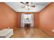 Bedroom with hardwood floors, ceiling fan, and large windows with a bedside table at 7972 Woods Lane, Jonesboro, GA 30236