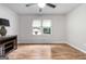 Bedroom featuring a ceiling fan, hardwood floors, and a window providing plenty of natural light at 7972 Woods Lane, Jonesboro, GA 30236