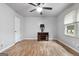 Bedroom featuring a ceiling fan, hardwood floors, and a window providing plenty of natural light at 7972 Woods Lane, Jonesboro, GA 30236