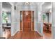 Inviting foyer with hardwood flooring and a beautiful wooden front door at 7972 Woods Lane, Jonesboro, GA 30236
