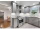 Updated kitchen featuring stainless steel appliances, stylish gray cabinets and hardwood floors at 7972 Woods Lane, Jonesboro, GA 30236