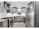 Modern kitchen featuring stainless steel appliances, gray cabinets and tile flooring at 7972 Woods Lane, Jonesboro, GA 30236