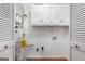 This laundry room features white cabinets and contains a hot water heater at 7972 Woods Lane, Jonesboro, GA 30236