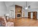 Spacious living room with vaulted ceiling, brick fireplace, hardwood floors and natural light at 7972 Woods Lane, Jonesboro, GA 30236