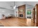 Spacious living room with vaulted ceiling, brick fireplace, hardwood floors and natural light at 7972 Woods Lane, Jonesboro, GA 30236