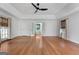 Open floor plan with hardwood flooring throughout the house, ceiling fan and good lighting at 7972 Woods Lane, Jonesboro, GA 30236
