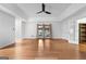 Spacious living room with hardwood floors, ceiling fan, and ample natural light from the large windows at 7972 Woods Lane, Jonesboro, GA 30236