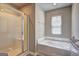 Bathroom featuring a soaking tub and glass enclosed shower at 237 Cranapple Ln, Mcdonough, GA 30253