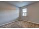 Comfortable bedroom with neutral carpet and a window overlooking the neighborhood at 237 Cranapple Ln, Mcdonough, GA 30253