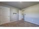 A tidy carpeted bedroom with installed tv mount and white paneled doors at 237 Cranapple Ln, Mcdonough, GA 30253
