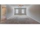 Large bedroom with neutral carpet, ceiling fan, and two windows for natural light at 237 Cranapple Ln, Mcdonough, GA 30253