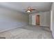 Spacious bedroom featuring neutral carpet, ceiling fan, and access to ensuite bathroom at 237 Cranapple Ln, Mcdonough, GA 30253
