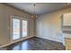 Dining room with hardwood floors, French doors to the backyard, and chandelier at 237 Cranapple Ln, Mcdonough, GA 30253