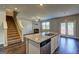 Open floorplan with staircase, living room, and kitchen island at 237 Cranapple Ln, Mcdonough, GA 30253