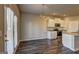 Open-concept kitchen and dining area with stainless steel appliances and wood flooring at 237 Cranapple Ln, Mcdonough, GA 30253