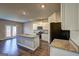 Modern kitchen with stainless steel appliances, granite countertops, white cabinets, and an island at 237 Cranapple Ln, Mcdonough, GA 30253
