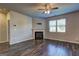 Living room with a fireplace, large windows, and a ceiling fan at 237 Cranapple Ln, Mcdonough, GA 30253
