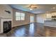 Open living room with a fireplace, large windows, access to the backyard, and a view of the kitchen at 237 Cranapple Ln, Mcdonough, GA 30253