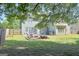 Large, fenced backyard with green grass and shade trees at 330 Bay Grove Rd, Loganville, GA 30052