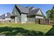 Spacious backyard with green lawn, privacy fence, and mature trees, creating a serene outdoor retreat at 330 Bay Grove Rd, Loganville, GA 30052