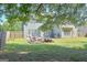 Large, fenced backyard with green grass and shade trees at 330 Bay Grove Rd, Loganville, GA 30052