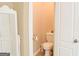 Powder room with white fixtures, toilet, and neutral tones at 330 Bay Grove Rd, Loganville, GA 30052