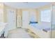 Bathroom with double vanity, soaking tub under a window, and tile flooring at 330 Bay Grove Rd, Loganville, GA 30052