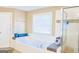 Bathroom featuring a large soaking tub, and a glass-enclosed shower at 330 Bay Grove Rd, Loganville, GA 30052