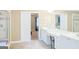 Bright bathroom featuring double vanity, shower, tub, and doorway to the bedroom at 330 Bay Grove Rd, Loganville, GA 30052