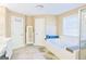 Bathroom with double vanity, soaking tub under a window, and tile flooring at 330 Bay Grove Rd, Loganville, GA 30052