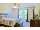Bedroom with ceiling fan, storage chest, large window, and TV on dresser at 330 Bay Grove Rd, Loganville, GA 30052
