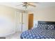 Cozy bedroom showcasing a neatly made bed with blue patterned bedding and a ceiling fan at 330 Bay Grove Rd, Loganville, GA 30052