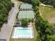 Aerial view of community pool and tennis courts surrounded by mature trees and ample parking at 330 Bay Grove Rd, Loganville, GA 30052