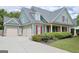 Charming home featuring a three-car garage, a covered porch, and well-maintained landscaping at 330 Bay Grove Rd, Loganville, GA 30052