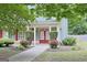 Charming home featuring a covered porch, red front doors, and well-maintained landscaping at 330 Bay Grove Rd, Loganville, GA 30052