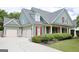 Charming home featuring a three-car garage, a covered porch, and well-maintained landscaping at 330 Bay Grove Rd, Loganville, GA 30052